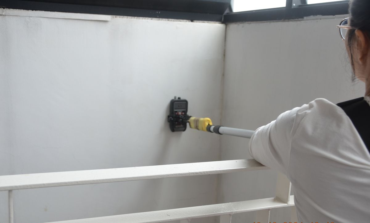 Surveyor inspecting balcony walls